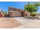 Spacious front yard featuring desert landscaping, a large tree, and a two-car garage at 45539 W Long Way, Maricopa, AZ 85139
