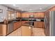 Spacious kitchen featuring wooden cabinets, granite countertops, and stainless steel appliances at 45539 W Long Way, Maricopa, AZ 85139