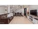 Open concept living room with tile flooring, a staircase, and comfortable seating at 45539 W Long Way, Maricopa, AZ 85139