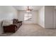 Inviting living room with carpet and a brown couch with a window allowing for great natural light at 45539 W Long Way, Maricopa, AZ 85139