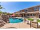 Backyard pool and patio with rock waterfall and outdoor seating, great for entertaining and relaxing at 45539 W Long Way, Maricopa, AZ 85139