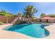Backyard pool with rock waterfall and easy to maintain desert landscaping is perfect for relaxing in style at 45539 W Long Way, Maricopa, AZ 85139