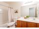 Bright bathroom with a shower-tub combo, wood vanity, and ample counter space at 4642 E Sierrita Rd, San Tan Valley, AZ 85143