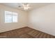 Simple bedroom featuring a large window offering natural light and a ceiling fan at 4642 E Sierrita Rd, San Tan Valley, AZ 85143