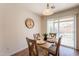 Cozy dining area featuring a table set for four, with backyard views through sliding glass door at 4642 E Sierrita Rd, San Tan Valley, AZ 85143