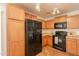 Modern kitchen featuring wood cabinets, and black appliances with lots of storage space at 4642 E Sierrita Rd, San Tan Valley, AZ 85143