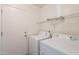 Functional laundry room featuring a washer, dryer, and wire shelving for storage at 4642 E Sierrita Rd, San Tan Valley, AZ 85143