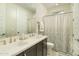 Bright bathroom features double sinks with modern fixtures and a shower/tub with a white shower curtain at 5109 E Helena Dr, Scottsdale, AZ 85254