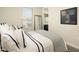 Cozy bedroom features neutral decor, a mirror, and a glimpse into the bright ensuite bathroom at 5109 E Helena Dr, Scottsdale, AZ 85254