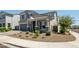 Charming two-story home features a covered front porch, manicured landscaping, and a two-car garage at 5109 E Helena Dr, Scottsdale, AZ 85254