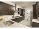 Modern kitchen with dark cabinets, stainless steel appliances, and white quartz countertops at 5109 E Helena Dr, Scottsdale, AZ 85254