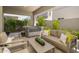 Relaxing outdoor patio with a hot tub, comfortable seating, and privacy landscaping at 5109 E Helena Dr, Scottsdale, AZ 85254