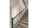 Carpeted staircase with a decorative black railing leading to the upper level at 5109 E Helena Dr, Scottsdale, AZ 85254