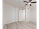 Bright bedroom features a ceiling fan, neutral walls, and light wood-look flooring at 5243 W Vernon Ave, Phoenix, AZ 85035