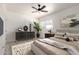 Nicely staged bedroom featuring a ceiling fan, large window, neutral colors and contemporary decor at 5243 W Vernon Ave, Phoenix, AZ 85035