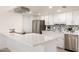 Bright kitchen features white cabinets, stainless steel appliances, and quartz countertops at 5243 W Vernon Ave, Phoenix, AZ 85035