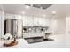 Modern kitchen featuring white cabinets, stainless steel appliances, and updated backsplash at 5243 W Vernon Ave, Phoenix, AZ 85035