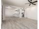 Spacious living room showcasing an open floorplan, wood-look floors, and white walls at 5243 W Vernon Ave, Phoenix, AZ 85035