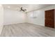 Clean and spacious living room with wood-look floors and modern ceiling fan at 5243 W Vernon Ave, Phoenix, AZ 85035