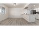 Spacious living room showcasing an open floorplan, wood-look floors, and white walls at 5243 W Vernon Ave, Phoenix, AZ 85035