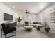 Staged living room featuring modern furniture and a ceiling fan at 5243 W Vernon Ave, Phoenix, AZ 85035