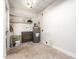 Practical utility room with shelving, water heater, and easy-to-clean concrete floor at 5243 W Vernon Ave, Phoenix, AZ 85035