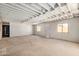 Spacious basement with concrete floor, wood paneled walls, and exposed ceiling joists at 6430 W Thomas Rd, Phoenix, AZ 85033