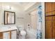 Cozy bathroom featuring a shower-tub combination, white toilet, and wooden vanity at 6430 W Thomas Rd, Phoenix, AZ 85033