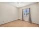 Bedroom featuring tile flooring and window with curtain at 6430 W Thomas Rd, Phoenix, AZ 85033