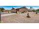 Charming brick home with unique arch detail, gravel landscaping, and fenced yard at 6430 W Thomas Rd, Phoenix, AZ 85033