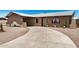 Lovely front of brick home with arch detail over carport and desert landscaping at 6430 W Thomas Rd, Phoenix, AZ 85033