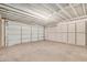 Clean and spacious garage featuring concrete floor and plenty of wall space at 6430 W Thomas Rd, Phoenix, AZ 85033