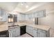 Bright kitchen offers ample storage, tile countertops, and modern black appliances at 6430 W Thomas Rd, Phoenix, AZ 85033