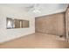 The living room shows tile flooring and a brick accent wall at 6430 W Thomas Rd, Phoenix, AZ 85033