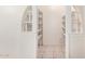 Walk-in pantry featuring decorative archway and custom shelving at 6430 W Thomas Rd, Phoenix, AZ 85033