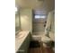 Bathroom featuring a toilet, a sink, vanity, and a shower with green accents at 6439 W Myrtle Ave # 49, Glendale, AZ 85301
