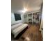 Bedroom featuring wood flooring, open closet space, and a comfy bed setup at 6439 W Myrtle Ave # 49, Glendale, AZ 85301