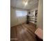 Bonus room featuring hardwood floors, shelving, and exercise equipment at 6439 W Myrtle Ave # 49, Glendale, AZ 85301