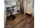 Bonus room or spare room featuring hardwood floors, shelving, and exercise equipment at 6439 W Myrtle Ave # 49, Glendale, AZ 85301