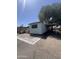 Single-story mobile home featuring brick trim and desert landscaping at 6439 W Myrtle Ave # 49, Glendale, AZ 85301