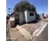 Single-story mobile home featuring brick trim and desert landscaping at 6439 W Myrtle Ave # 49, Glendale, AZ 85301