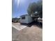 Single-story mobile home featuring brick trim and desert landscaping at 6439 W Myrtle Ave # 49, Glendale, AZ 85301