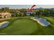 Aerial view of the property, nestled on a lush golf course with mountain views in the distance at 7222 E Gainey Ranch Rd # 245, Scottsdale, AZ 85258