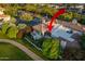 Expansive aerial perspective of a home with a tile roof, lush landscaping, and inviting outdoor living spaces at 7222 E Gainey Ranch Rd # 245, Scottsdale, AZ 85258