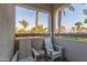 Cozy balcony featuring two chairs and serene palm tree views at 7222 E Gainey Ranch Rd # 245, Scottsdale, AZ 85258
