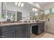 Bright bathroom with double vanity and marble countertops at 7222 E Gainey Ranch Rd # 245, Scottsdale, AZ 85258