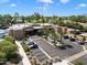 Beautiful community center with well-maintained landscaping, featuring lush greenery, palm trees, ample parking, and sidewalks at 7222 E Gainey Ranch Rd # 245, Scottsdale, AZ 85258