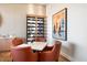 Stylish dining area with seating for four, complemented by a modern wine rack and contemporary artwork at 7222 E Gainey Ranch Rd # 245, Scottsdale, AZ 85258