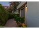 Charming entrance with a well-manicured hedge and a cozy, inviting pathway to the front door at 7222 E Gainey Ranch Rd # 245, Scottsdale, AZ 85258