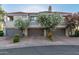 Townhome complex with garages and well-maintained landscaping, exuding curb appeal in a tranquil neighborhood at 7222 E Gainey Ranch Rd # 245, Scottsdale, AZ 85258